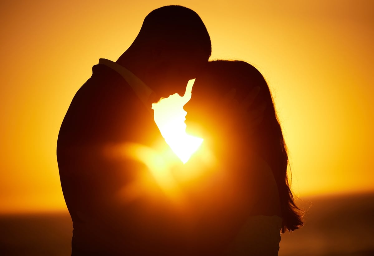 Romantic couple silhouette at sunset
