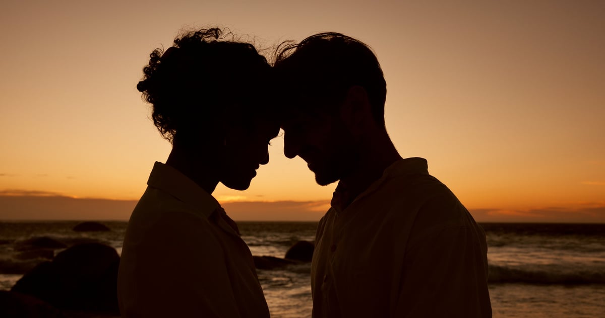 Couple at beach sunset bonding together